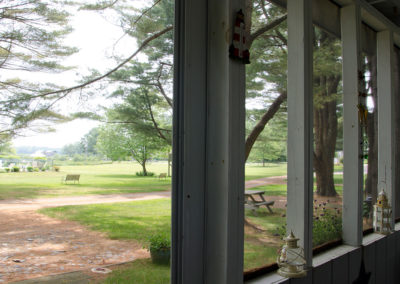A view of a grassy field through a window.