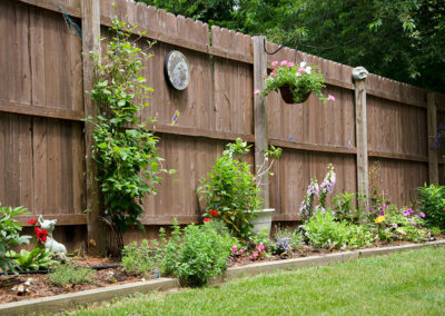 A wooden fence in a backyard.