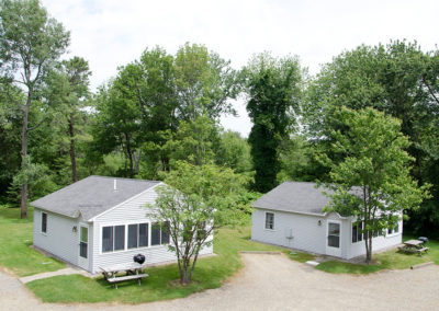 Two cottages with a gravel driveway